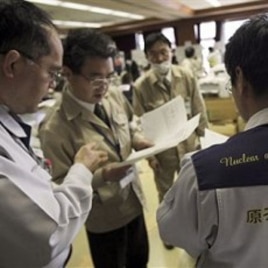 Teams of government and nuclear specialists at the emergency rescue headquarters analyze data from the leaked radiation from the Fukushima nuclear facilitiesin Fukushima, Japan, March 19, 2011