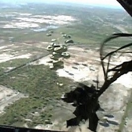This image taken from video shows relief supplies parachuting from a US Air Force cargo plane flying over Haiti, 19 January 2010 Author: US Air Force