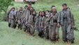 Kurdistan Workers Party (PKK) fighters walk on the way to their new base in northern Iraq May 14, 2013. The first group of Kurdish militants to withdraw from Turkey under a peace process entered northern Iraq on Tuesday, and were greeted by comrades from 