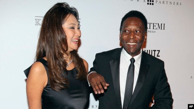 FILE - Brazilian soccer great Pele and businesswoman Marcia Cibele Aoki pose on the red carpet of The Foundation for AIDS Research event in Sao Paulo, Brazil, April 5 2013. 