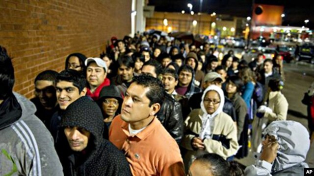 Hundreds of early-morning shoppers get in line the night before hoping to snag a deal on Black Friday at Best Buy in Atlanta, 26 Nov 2010