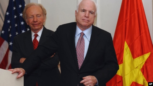 US Senator John McCain (R) speaks next to US Senator Joseph Lieberman (on left) at a press conference in Hanoi on January 19, 2012.