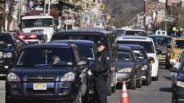 Police direct cars to gas pumps outside a gas station in the Brooklyn borough of New York, November 9, 2012.