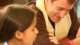 Room to Read founder John Wood reads to a girl in Nepal. (Andrea McTamaney)