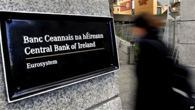 Woman enters offices of Central Bank in Dublin, Ireland.