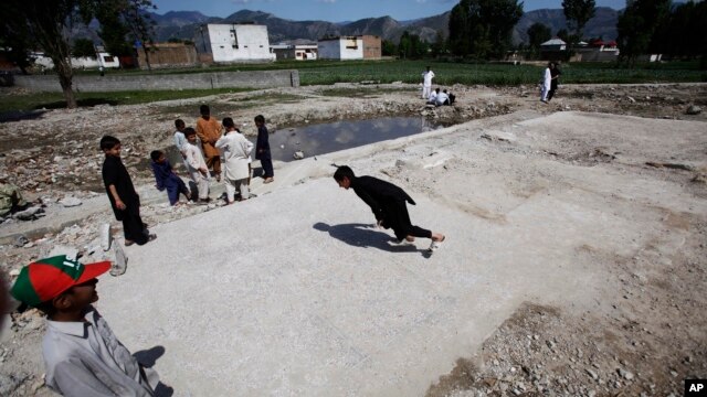 Pakistani boys play at the demolished compound of Osama bin Laden, in Abbottabad, Pakistan, May 2, 2012. 