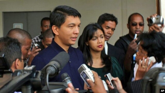 Madagascar's leader Andry Rajoelina speaks to the press after casting his vote at a local polling station in Antananarivo on November 17, 2010. Madagascans went to the polls on November 17 to vote on a constitutional referendum organised by the island's c