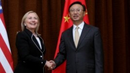U.S. Secretary of State Hillary Rodham Clinton, left, and Chinese Foreign Minister Yang Jiechi, right, shake hands during her visit to Beijing, Sept. 4, 2012.