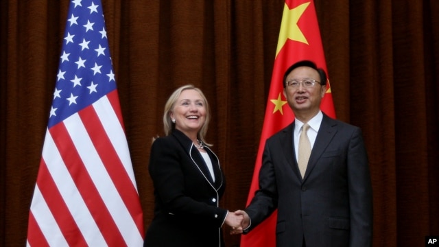 U.S. Secretary of State Hillary Rodham Clinton, left, and Chinese Foreign Minister Yang Jiechi, right, shake hands during her visit to Beijing, Sept. 4, 2012.