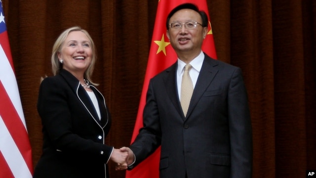 U.S. Secretary of State Hillary Rodham Clinton, left, and Chinese Foreign Minister Yang Jiechi, right, shake hands during her visit to Beijing, Sept. 4, 2012.