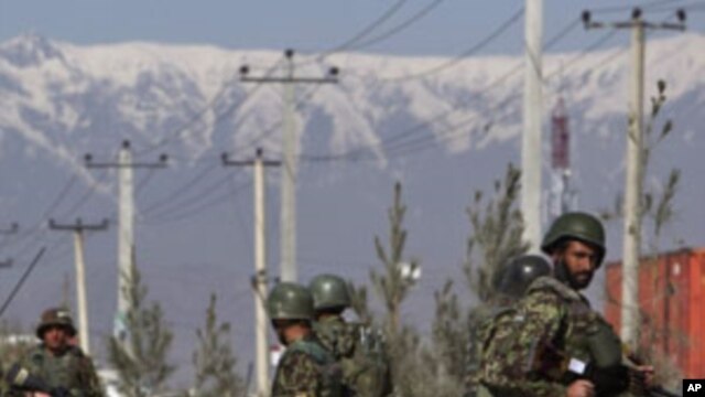 An Afghan National Army soldiers keeps watch after an attack at Camp Phoenix in Kabul April 2, 2011