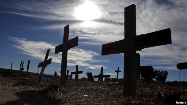Crosses fill a graveyard in Cape Town's Khayelitsha township February 27, 2010. Many of those buried in the South African cemetery died from AIDS or related complications such as tuberculosis (TB).