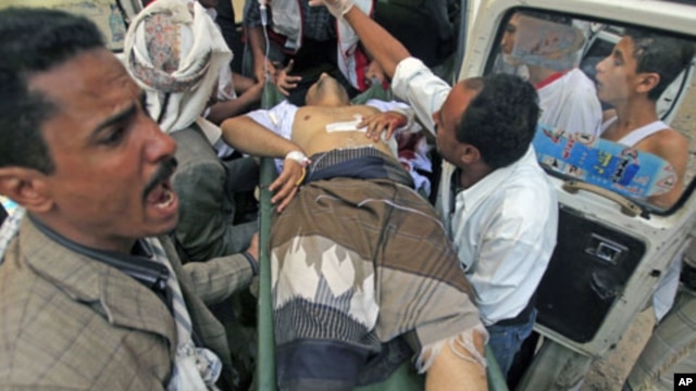 An injured opposition fighter rushed to a hospital after clashes with government security forces in the southern city of Taiz, Yemen, November 2, 2011.