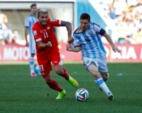 Switzerland's Valon Behrami challenges Argentina's Lionel Messi during extra time in their 2014 World Cup round of 16 game at the Corinthians arena in Sao Paulo July 1, 2014.