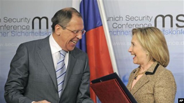US Secretary of State Hillary Rodham Clinton, right, and Russia's Foreign Minister Sergey Lavrov smile after finalizing the New START treaty during the Conference on Security Policy in Munich, Germany, February 5, 2011