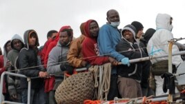 Migrants waits to leave a tugboat after being rescued in Porto Empedocle, Sicily earlier this year.
