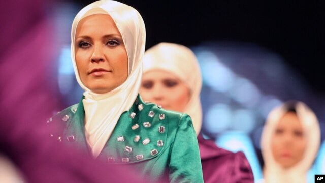Models wear creations by a Turkish Islamic fashion house for its spring-summer 2008 ready-to-wear collection in Ankara, Turkey, Monday, March 3, 2008.