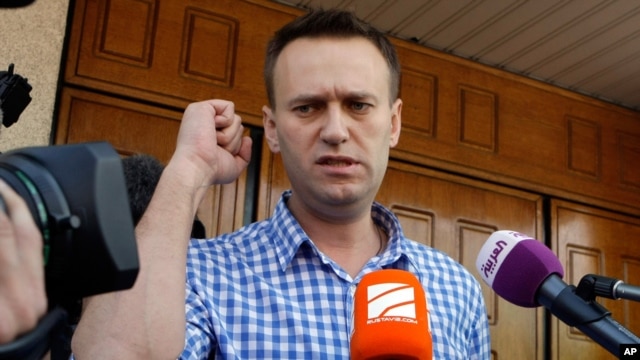 Russian opposition leader Alexei Navalny speaks to the media at the headquarters of the Russian Investigation committee in Moscow, Russia, June 12, 2012.