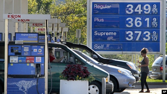 In this September 27, 201 photo, cars line up at the pumps at an Exxon mini-mart in Carnegie, Pennsylvania.