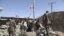 Afghan security forces investigate the site of a bomb blast in Helmand province October 8, 2012. At least four Afghan intelligence personnel were killed and 16 others, including civilians, wounded in the car bomb blast on Monday, officials said.   REUTERS