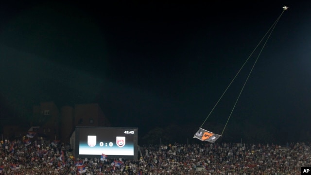 FILE - A drone with an Albanian flag flies over Partizan stadium during the Euro 2016 Group I qualifying match between Serbia and Albania in Belgrade, Serbia, Oct. 14, 2014.  