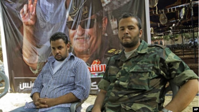 Motasin Younis, left, and Mohammed Hamed Younis, right, son and nepheiw of Libyan rebels' slain military chief Abdel-Fattah Younis seen during a interview in  rebel-held Benghazi, Libya,  Aug. 1, 2011