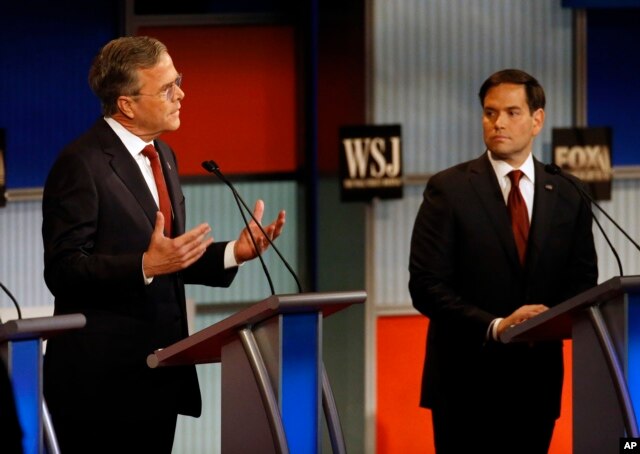 Jeb Bush, left, speaks as Marco Rubio listens during Republican presidential debate at Milwaukee Theatre, Tuesday, Nov. 10, 2015, in Milwaukee.