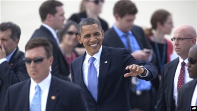 President Barak Obama greets supporters on the tarmac of the Grand Rapids, Mich. airport, Thursday, Aug. 11, 2011, on his way to Holland, Mich. (AP Photo/Adam Bird)