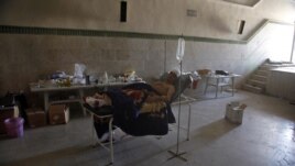 Mahmoud, 21, a Palestinian resident of Syria, rests in a field hospital after he was found Monday, August 6, 2012, with three gunshot wounds on the outskirts of Aleppo, Syria.
