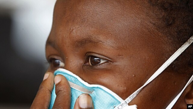 TB patient covers her face at clinic near Cape Town, South Africa, March 24, 2011 (file photo).