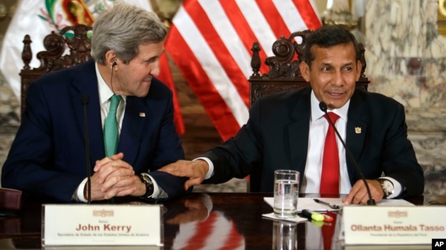 Peru's President Ollanta Humala, right, jokes with U.S. Secretary of State John Kerry — in Lima for a conference on climate change — as they talk to reporters following a private meeting in the Peruvian capital, Dec. 11, 2014.