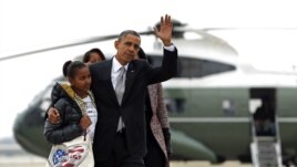 President Barack Obama,Michelle Obama and their daughters Sasha and Malia, walk from Marine One to board Air Force One at Chicago O'Hare International Airport, Nov. 7, 2012, in Chicago.