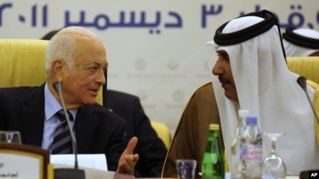 Qatar's Prime Minister and Foreign Minister Hamad bin Jassim bin Jabr Al-Thani (R) speaks with Arab League Secretary General Nabil al-Arabi during a meeting of the Committee of Arab Coordination in Doha, December 3, 2011.