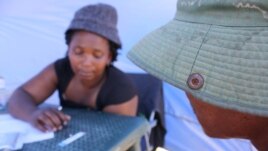 Nurse Nokwezi Dishi counsels a man who’s just tested positive for HIV (D. Taylor/VOA)