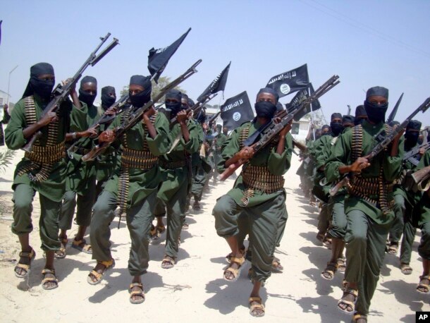 FILE - Al-Shabab fighters are seen marching with their weapons during exercises on the outskirts of Mogadishu, Somalia.