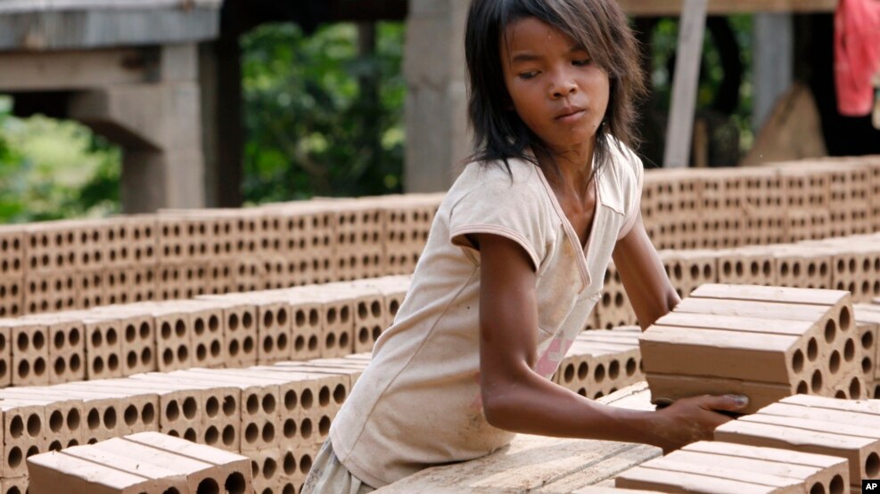 A Cambodian girl prepares bricks to dry under the sun light at a brick factory in Chheuteal village, Kandal province, some 27 kilometers (17 miles) north of Phnom Penh, Cambodia, Monday, May 2, 2011. 