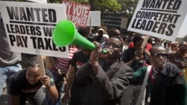 Kenyans demonstrate against their Members of Parliament who last week quietly awarded themselves a $110,000 bonus for five years of service in parliament, in downtown Nairobi, Kenya, October 9, 2012.