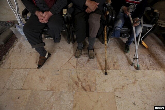 Men with amputated limbs wait to be inspected in the rebel-controlled area of Maaret al-Numan town in Idlib province, Syria, March 20, 2016.