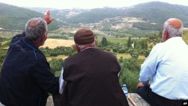 Residents of Güveççi, Turkey, look across the valley to Syria, June 11 2011