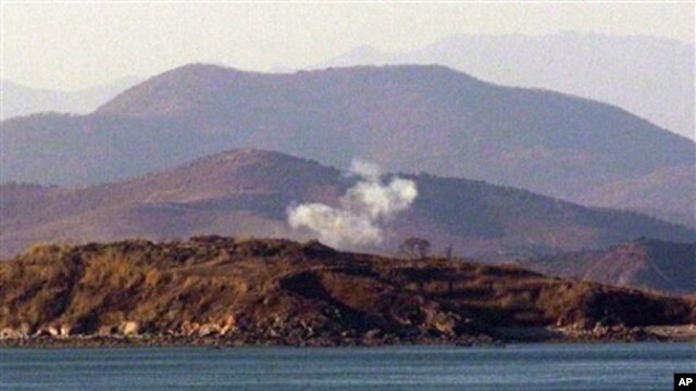 Smoke rises on the Yeonpyeong Island, South Korea, 26 Nov  2010