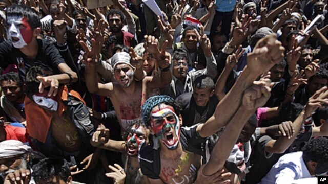 Yemeni protesters, their faces colored with their national flag and Arabic writing that reads "stop killing the innocent", chant anti-government slogans during a demonstration demanding the resignation of President Ali Abdullah Saleh in Sana'a, October 11