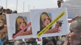 A protester holds up an sign protesting against UNMISS head Hilde Johnson at a rally in Juba.