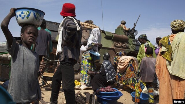 A French armored vehicle drives on a road next to the central market in Diabaly, Mali, January 23, 2013.
