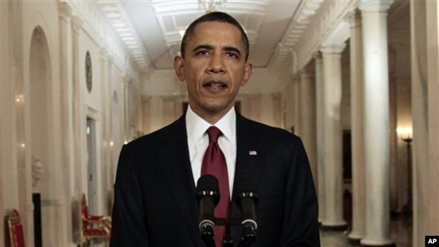 President Barack Obama reads his statement to photographers after making a televised statement on the death of Osama bin Laden from the East Room of the White House in Washington, Sunday, May 1, 2011.  (AP Photo/Pablo Martinez Monsivais)