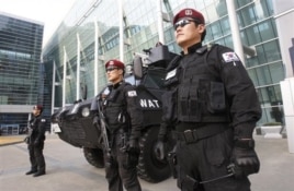 Police officers stand guard in front of the venue of Fourth High-Level Forum on Aid Effectiveness in Busan.
