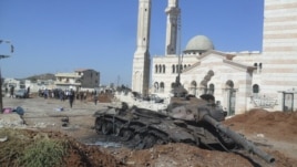 A burned tank belonging to government forces is seen in Azzaz, Aleppo province, Syria July 19, 2012.
