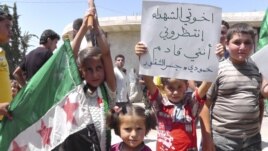 Young demonstrators protest against Syria's President Bashar al-Assad in Al Kasten, near Idlib,June 29, 2012.