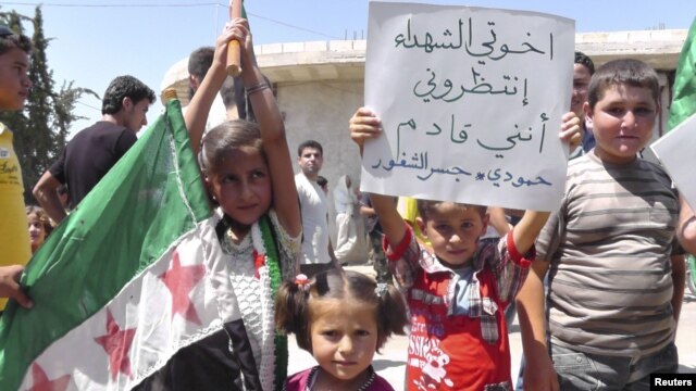 Young demonstrators protest against Syria's President Bashar al-Assad in Al Kasten, near Idlib,June 29, 2012.