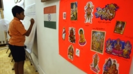 A poster displaying the religions of India and the Indian flag hang on the wall at the India Heritage Camp in 2006. A new study shows Hindus are more educated and earn more than any other religion in the U.S.