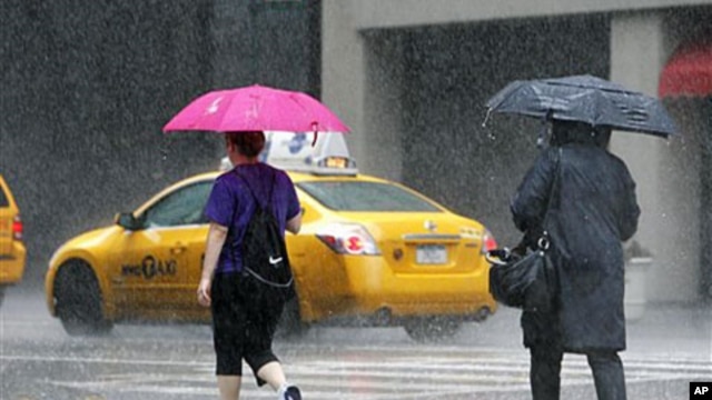 Pedestrians walk in a heavy downpour on Lexington Avenue in New York City as Hurricane Irene moves up the East Coast, August. 27, 2011